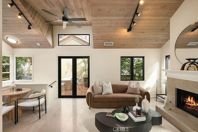 4411/2 Goldenrod Ave, Corona Del Mar, CA 92625 - tiled living room featuring rail lighting, wood ceiling, a premium fireplace, french doors, and ceiling fan