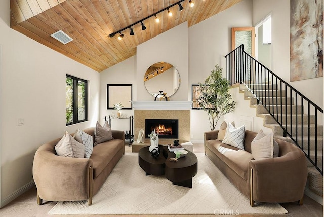 4411/2 Goldenrod Ave, Corona Del Mar, CA 92625 - living area featuring wooden ceiling, track lighting, a warm lit fireplace, high vaulted ceiling, and stairs
