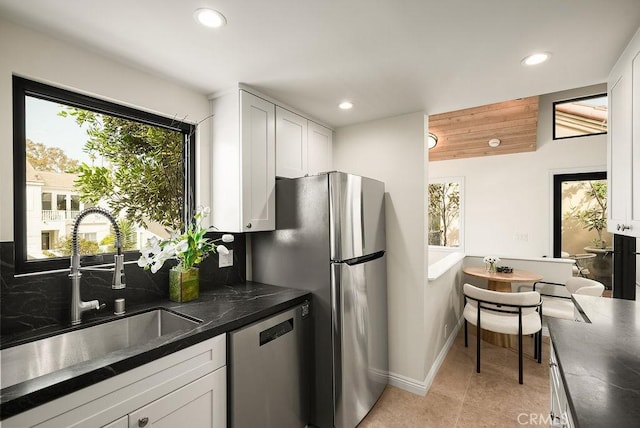4411/2 Goldenrod Ave, Corona Del Mar, CA 92625 - kitchen with stainless steel appliances, recessed lighting, dark countertops, white cabinetry, and light tile patterned floors