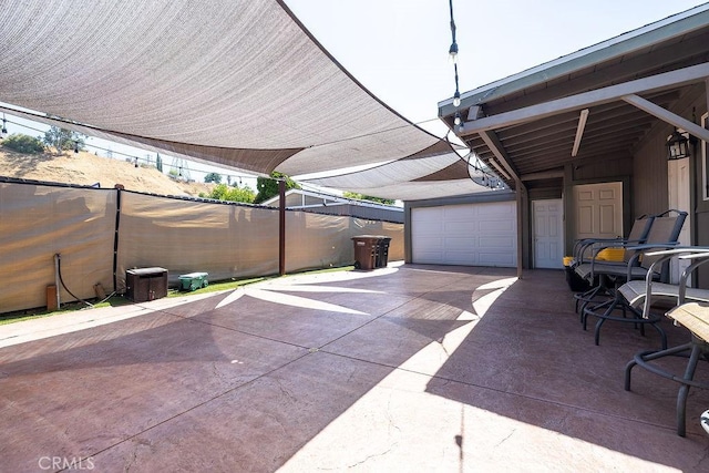 700 E Washington St Unit 143, Colton, CA 92324 - view of patio / terrace featuring a garage and concrete driveway