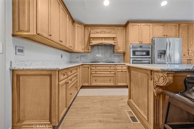 700 E Washington St Unit 143, Colton, CA 92324 - kitchen with appliances with stainless steel finishes, custom range hood, light wood-type flooring, light stone countertops, and decorative backsplash