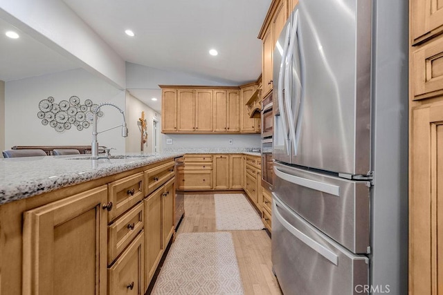 700 E Washington St Unit 143, Colton, CA 92324 - kitchen with stainless steel appliances, lofted ceiling, light wood-style floors, recessed lighting, and light stone counters