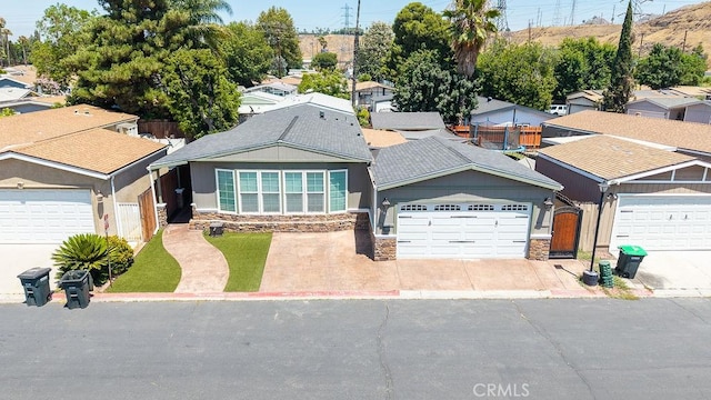 700 E Washington St Unit 143, Colton, CA 92324 - single story home featuring stone siding, driveway, and a residential view