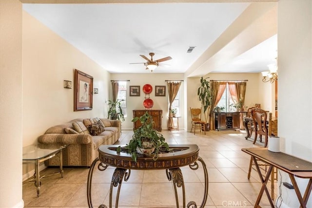 19247 Mountain Shadow Ln, Perris, CA 92570 - living area featuring healthy amount of natural light, light tile patterned floors, a ceiling fan, and a chandelier