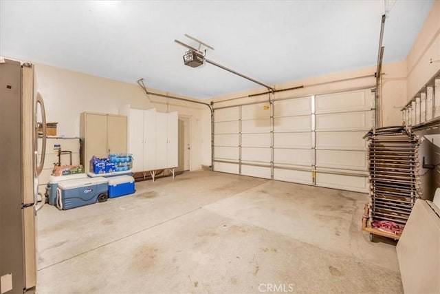 19247 Mountain Shadow Ln, Perris, CA 92570 - garage featuring a garage door opener and freestanding refrigerator