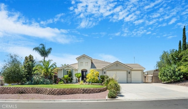 19247 Mountain Shadow Ln, Perris, CA 92570 - mediterranean / spanish-style home featuring an attached garage, driveway, stucco siding, and a tile roof