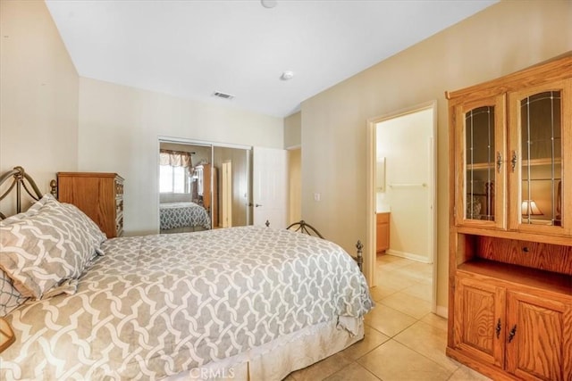 19247 Mountain Shadow Ln, Perris, CA 92570 - bedroom featuring light tile patterned floors, connected bathroom, and a closet