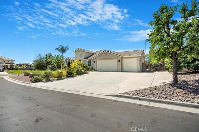 19247 Mountain Shadow Ln, Perris, CA 92570 - view of front facade with a garage, driveway, stucco siding, and a tiled roof