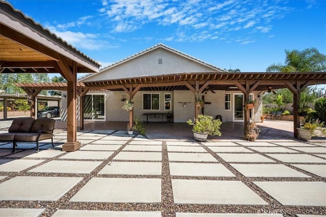 19247 Mountain Shadow Ln, Perris, CA 92570 - rear view of house with stucco siding, a patio, and a pergola