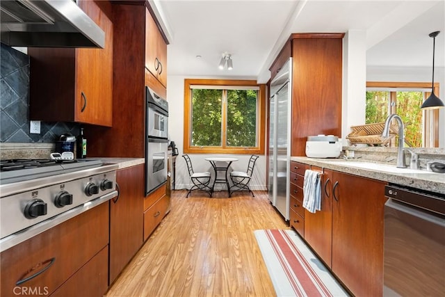 411 N Oakhurst Dr Unit 201, Beverly Hills, CA 90210 - kitchen featuring stainless steel appliances, healthy amount of natural light, ventilation hood, and light wood-type flooring