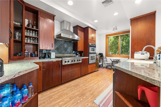 411 N Oakhurst Dr Unit 201, Beverly Hills, CA 90210 - kitchen featuring wall chimney exhaust hood, open shelves, stainless steel appliances, light wood-style floors, and recessed lighting