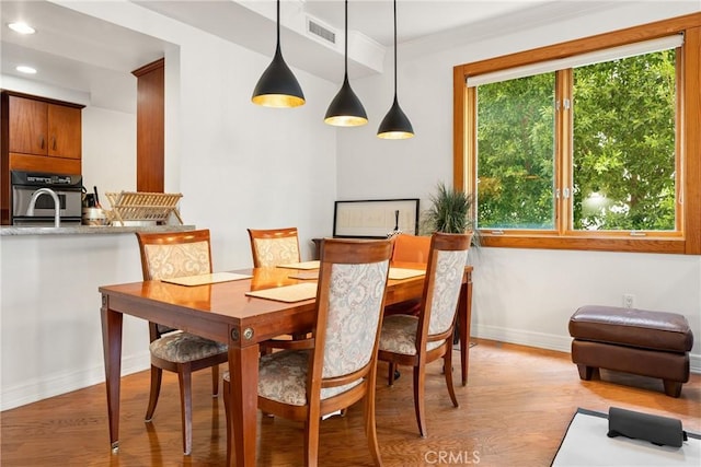 411 N Oakhurst Dr Unit 201, Beverly Hills, CA 90210 - dining space with light wood-style flooring, recessed lighting, and crown molding