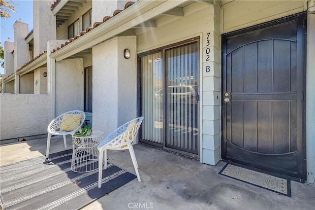 7302 Bright Ave Unit B, Whittier, CA 90602 - doorway to property with stucco siding, a tiled roof, and a chimney