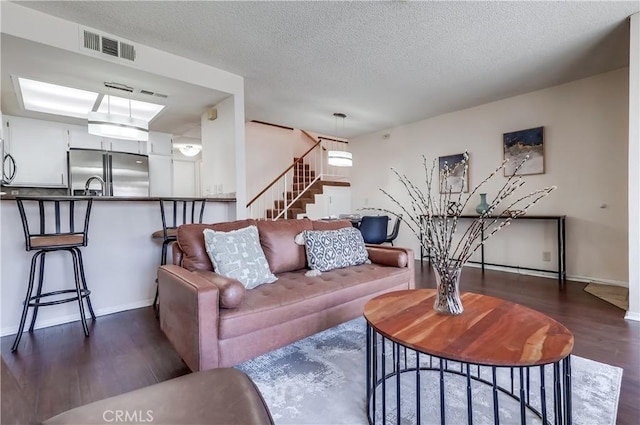 7302 Bright Ave Unit B, Whittier, CA 90602 - living room with dark wood-style flooring, stairway, and a textured ceiling