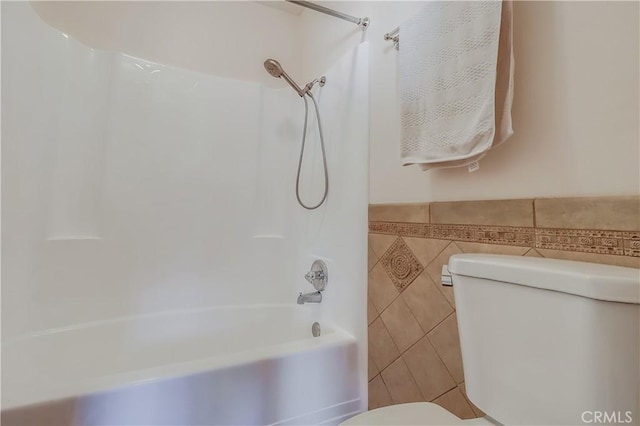 7302 Bright Ave Unit B, Whittier, CA 90602 - bathroom featuring tile walls, bathtub / shower combination, a wainscoted wall, and tile patterned floors