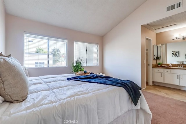 7302 Bright Ave Unit B, Whittier, CA 90602 - bedroom featuring lofted ceiling, attic access, light carpet, and connected bathroom