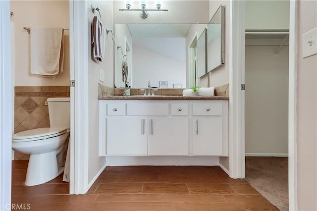 7302 Bright Ave Unit B, Whittier, CA 90602 - bathroom with vanity, tile walls, wood tiled floors, wainscoting, and a spacious closet