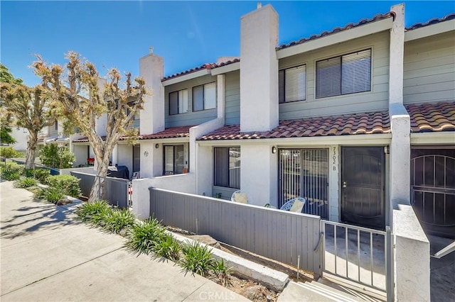 7302 Bright Ave Unit B, Whittier, CA 90602 - back of house with a tiled roof, a chimney, and stucco siding