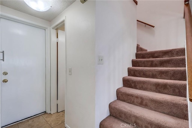 7302 Bright Ave Unit B, Whittier, CA 90602 - stairway featuring tile patterned floors and a textured ceiling