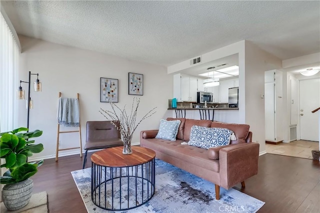 7302 Bright Ave Unit B, Whittier, CA 90602 - living room featuring dark wood-style flooring and a textured ceiling