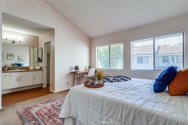 7302 Bright Ave Unit B, Whittier, CA 90602 - bedroom with carpet, vaulted ceiling, a textured ceiling, and ensuite bathroom