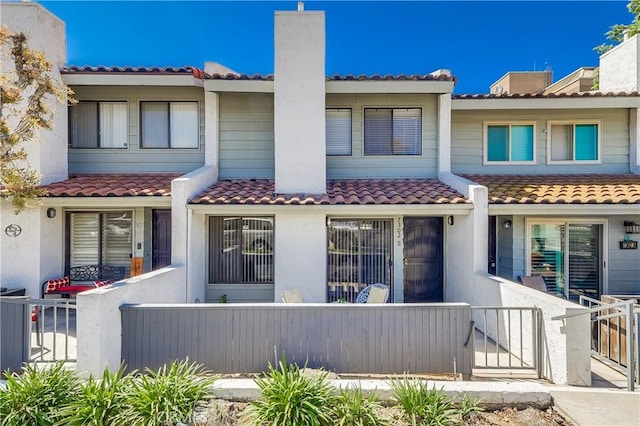 7302 Bright Ave Unit B, Whittier, CA 90602 - view of front of home with a chimney, stucco siding, and a tile roof