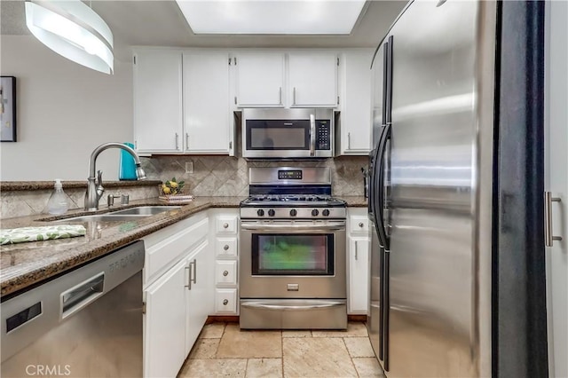 7302 Bright Ave Unit B, Whittier, CA 90602 - kitchen featuring appliances with stainless steel finishes, stone counters, white cabinetry, and decorative backsplash