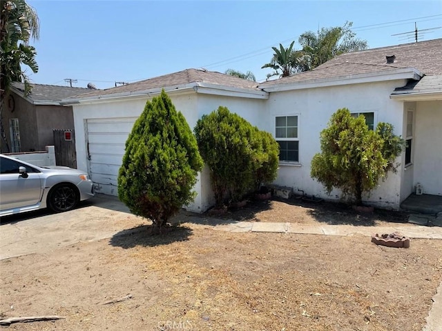 11250 Victory Blvd, North Hollywood, CA 91606 - view of property exterior with a shingled roof, stucco siding, and an attached garage