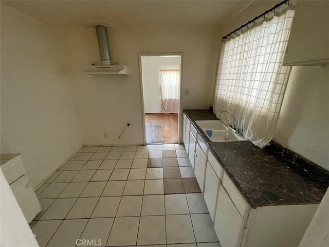 11250 Victory Blvd, North Hollywood, CA 91606 - kitchen featuring white cabinets, dark countertops, and light tile patterned floors