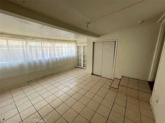 11250 Victory Blvd, North Hollywood, CA 91606 - empty room with light tile patterned floors and a smoke detector