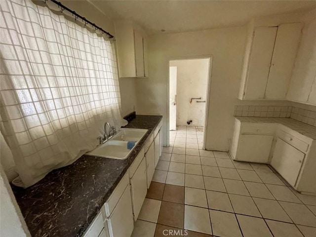 11250 Victory Blvd, North Hollywood, CA 91606 - kitchen featuring backsplash, white cabinetry, and light tile patterned flooring