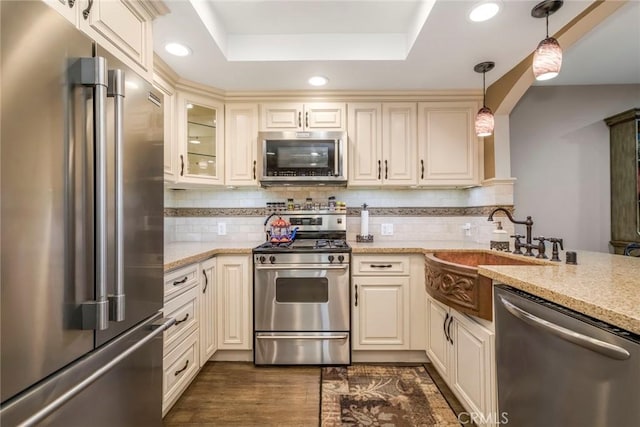 23130 Yvette Ln, Valencia, CA 91355 - kitchen with stainless steel appliances, a tray ceiling, light stone counters, and recessed lighting