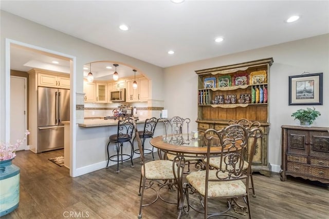 23130 Yvette Ln, Valencia, CA 91355 - dining area featuring wood finished floors, recessed lighting, and arched walkways
