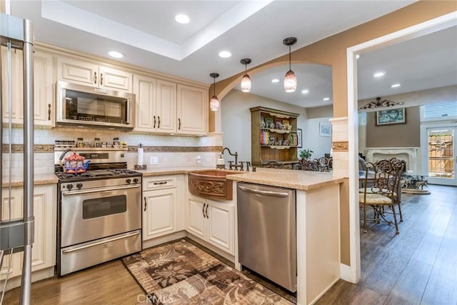 23130 Yvette Ln, Valencia, CA 91355 - kitchen featuring appliances with stainless steel finishes, wood finished floors, tasteful backsplash, decorative light fixtures, and recessed lighting