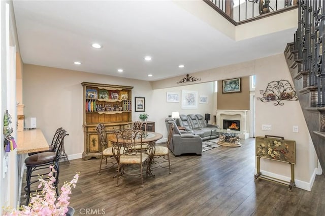 23130 Yvette Ln, Valencia, CA 91355 - dining area featuring a warm lit fireplace, dark wood-style floors, recessed lighting, and plenty of natural light
