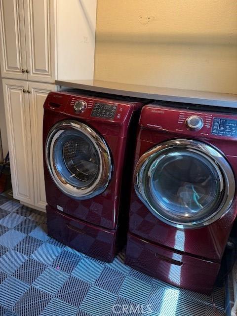 23130 Yvette Ln, Valencia, CA 91355 - laundry room with washing machine and dryer and cabinet space