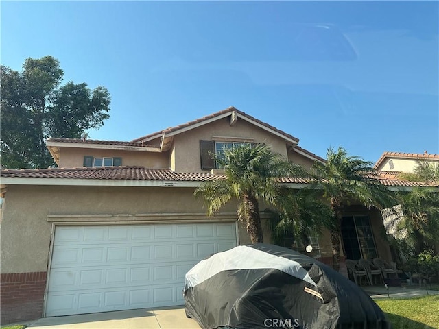 16200 Coleen St, Fontana, CA 92337 - view of front facade featuring a garage, brick siding, stucco siding, and concrete driveway