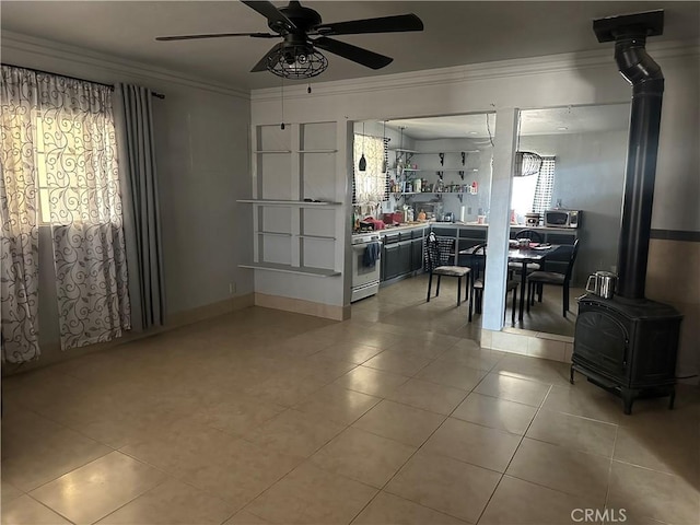 3938 Kreuer Rd, Phelan, CA 92371 - dining space with a wood stove, ceiling fan, ornamental molding, and light tile patterned floors