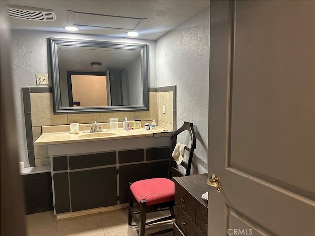 3938 Kreuer Rd, Phelan, CA 92371 - bathroom with a textured wall, vanity, tile patterned floors, and backsplash
