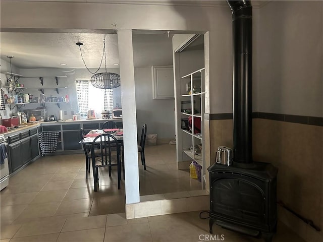 3938 Kreuer Rd, Phelan, CA 92371 - dining space featuring a wood stove and light tile patterned floors