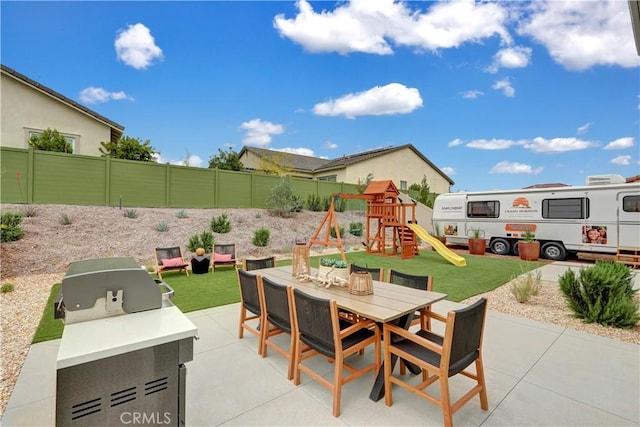 17163 Kent St, Hesperia, CA 92345 - fenced backyard with outdoor dining space, a patio area, grilling area, and a playground