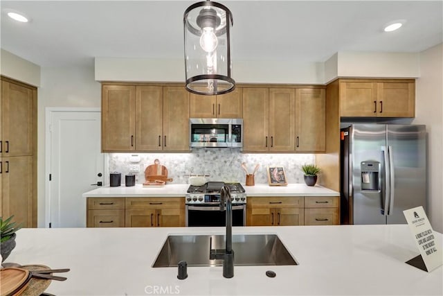 17163 Kent St, Hesperia, CA 92345 - kitchen featuring stainless steel appliances, light countertops, tasteful backsplash, brown cabinets, and recessed lighting