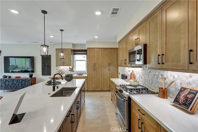 17163 Kent St, Hesperia, CA 92345 - kitchen featuring stainless steel appliances, tasteful backsplash, light countertops, pendant lighting, and recessed lighting