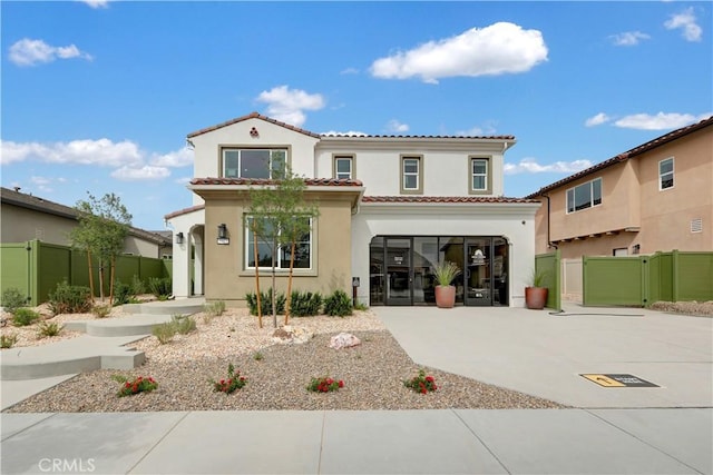 17163 Kent St, Hesperia, CA 92345 - mediterranean / spanish home featuring stucco siding, a tile roof, driveway, an attached garage, and a gate