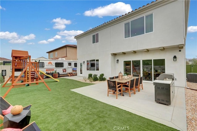 17163 Kent St, Hesperia, CA 92345 - back of house featuring a playground, a patio area, and stucco siding