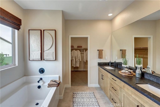 17163 Kent St, Hesperia, CA 92345 - bathroom featuring double vanity, a walk in closet, a bath, and tile patterned floors
