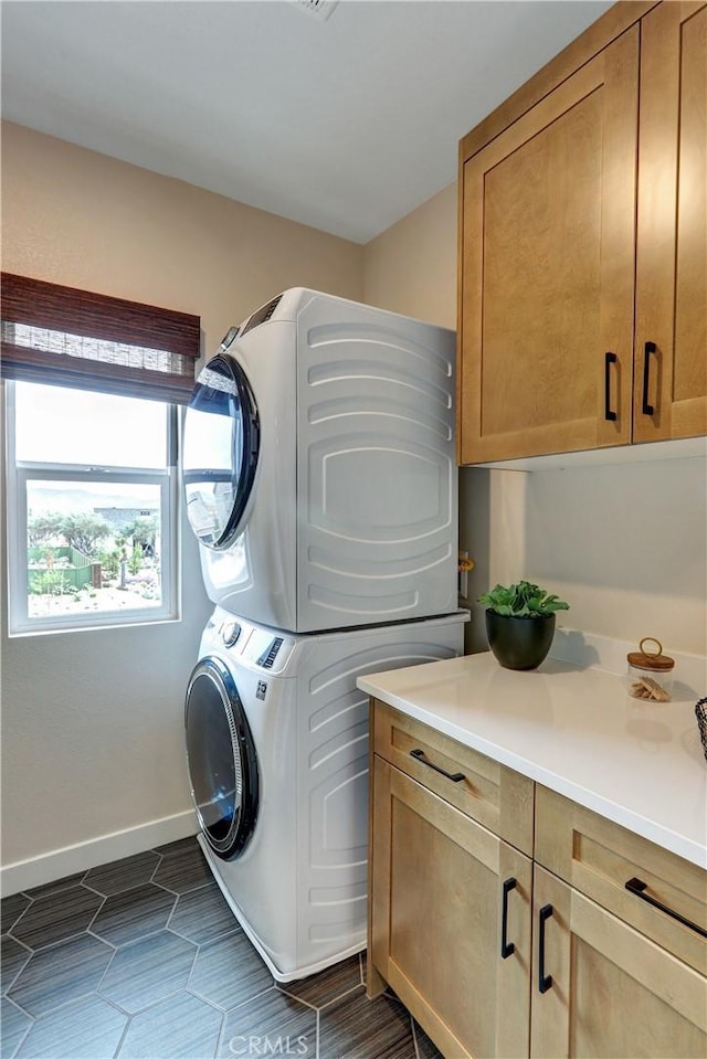 17163 Kent St, Hesperia, CA 92345 - laundry room featuring stacked washer and clothes dryer and cabinet space
