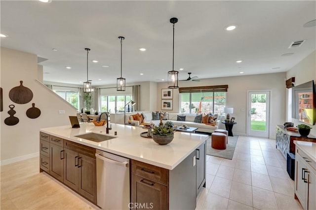 17163 Kent St, Hesperia, CA 92345 - kitchen featuring stainless steel dishwasher, open floor plan, healthy amount of natural light, recessed lighting, and a center island with sink