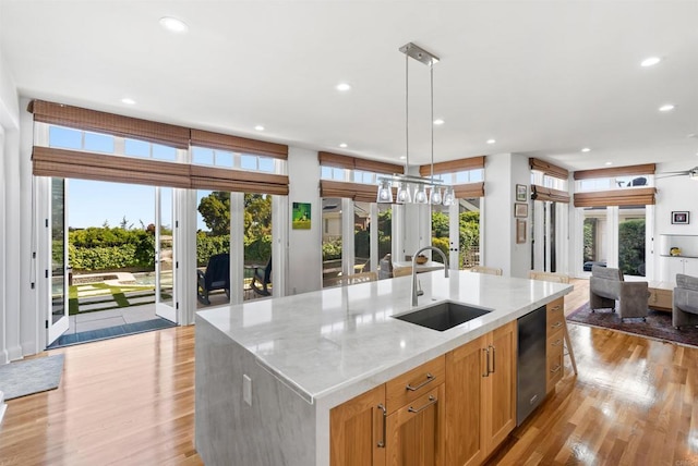 6815 La Jolla Scenic Dr, La Jolla, CA 92037 - kitchen with open floor plan, recessed lighting, light wood-style flooring, light stone countertops, and an island with sink