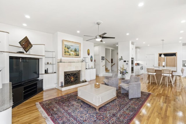 6815 La Jolla Scenic Dr, La Jolla, CA 92037 - living area with ceiling fan, light wood finished floors, stairway, recessed lighting, and a fireplace
